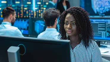 African woman sitting in front of computer analyzing data