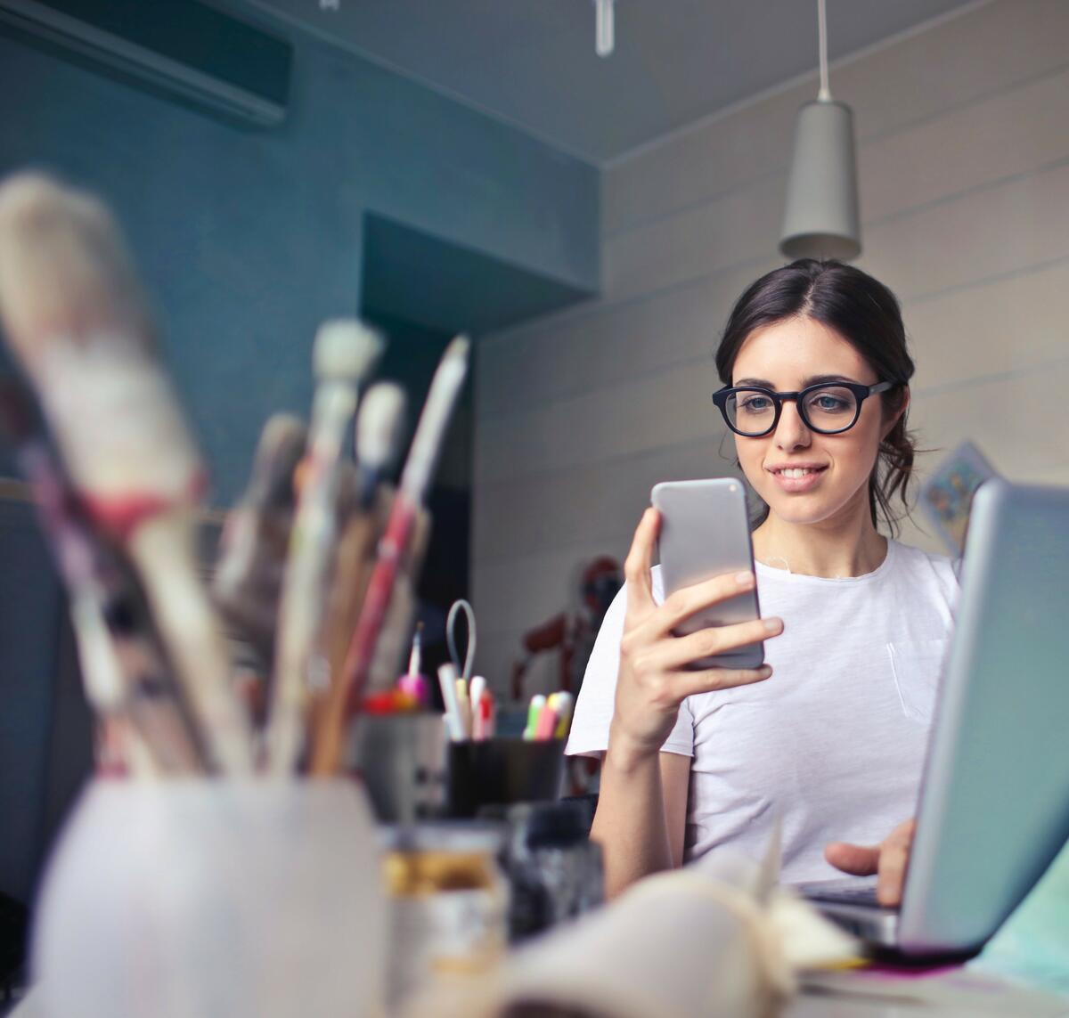 Article Cover of a girl using her phone and laptop in Color