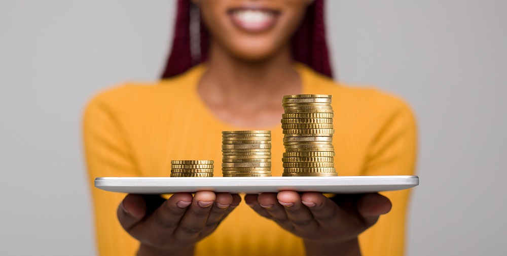 African Women holding a table with coin stacks