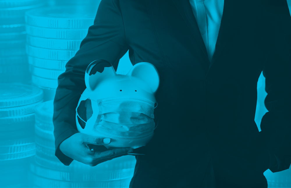 Man in suit, holding a piggy bank with mask and coins in the background