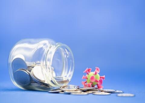 jar with coins and a coronavirus cell toy