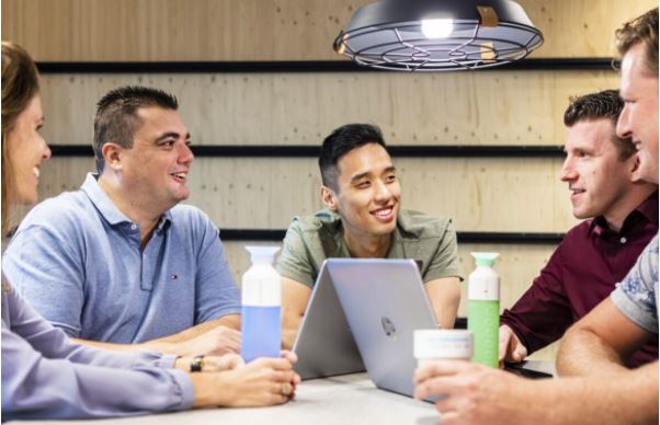 Article cover with people talking at a table in color